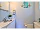 Bathroom features decor, a towel rack, an updated vanity and sink, and updated toilet at 1500 Robinson N Dr, St Petersburg, FL 33710