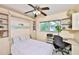 Comfortable bedroom with a built-in murphy bed, a ceiling fan, a workspace, and natural light from the window at 1500 Robinson N Dr, St Petersburg, FL 33710