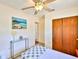 Bedroom with an ensuite bathroom, a decorative shelf, and a large wardrobe at 1500 Robinson N Dr, St Petersburg, FL 33710