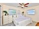 Charming bedroom featuring two windows, plush pillows, and decoratively styled dressers at 1500 Robinson N Dr, St Petersburg, FL 33710