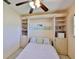 Comfortable bedroom features a built-in Murphy bed surrounded by custom shelving and storage cabinets at 1500 Robinson N Dr, St Petersburg, FL 33710