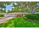 Charming single-story home with a lush green lawn, mature trees, and a cozy, inviting exterior at 1500 Robinson N Dr, St Petersburg, FL 33710