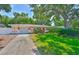 Inviting single-story home with well-maintained lawn, vibrant landscaping, and a quaint, welcoming facade at 1500 Robinson N Dr, St Petersburg, FL 33710