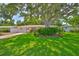 Charming single-story home with a lush green lawn, mature trees, and a cozy, inviting exterior at 1500 Robinson N Dr, St Petersburg, FL 33710