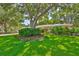 Landscaped front yard with mature trees and lush green lawn at 1500 Robinson N Dr, St Petersburg, FL 33710