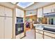 View of the kitchen showcasing the stainless steel appliances, the open layout and a peek into the adjacent living space at 1500 Robinson N Dr, St Petersburg, FL 33710