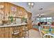 Open concept kitchen with wood paneling, a breakfast bar with seating, and a view into the living room at 1500 Robinson N Dr, St Petersburg, FL 33710