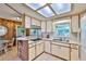 Well-lit kitchen featuring updated cabinetry, a breakfast bar, and a seamless flow into the dining area at 1500 Robinson N Dr, St Petersburg, FL 33710