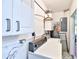 Bright laundry area featuring updated washer and dryer, storage, and a utility sink at 1500 Robinson N Dr, St Petersburg, FL 33710