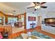 Bright living room featuring wood floors, a ceiling fan, a decorative wall art, and seamlessly connects to the kitchen at 1500 Robinson N Dr, St Petersburg, FL 33710