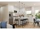 Well-lit kitchen with stainless steel appliances, a center island with seating, and pendant lighting at 16 Heather Ter, North Port, FL 34286