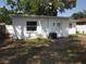 Exterior view of the property highlighting the detached garage and AC unit at 162 Sw Lincoln N Cir, St Petersburg, FL 33703