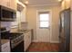 Modern kitchen with stainless steel appliances, granite countertops, white cabinets and hardwood flooring at 162 Sw Lincoln N Cir, St Petersburg, FL 33703