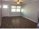 Well lit, spacious living room with hardwood floors, a ceiling fan, and a large window for natural light at 162 Sw Lincoln N Cir, St Petersburg, FL 33703