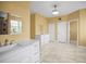 Spacious bathroom with double sinks, stylish fixtures, and tile flooring at 1768 Lago Vista Blvd, Palm Harbor, FL 34685