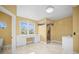 Bathroom featuring a built-in desk, large window, and a glass-enclosed walk-in shower at 1768 Lago Vista Blvd, Palm Harbor, FL 34685