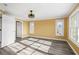 Bright, airy bedroom featuring wood floors, updated windows, a ceiling fan, and neutral decor at 1768 Lago Vista Blvd, Palm Harbor, FL 34685