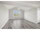 Bright bedroom featuring wood floors, a vaulted ceiling, and an overhead ceiling fan at 1768 Lago Vista Blvd, Palm Harbor, FL 34685