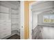 Spacious walk-in closet boasting built-in shelving and storage drawers at 1768 Lago Vista Blvd, Palm Harbor, FL 34685