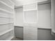 Organized walk-in closet featuring built-in shelving and storage drawers at 1768 Lago Vista Blvd, Palm Harbor, FL 34685