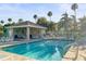 Resort-style community pool with a cabana and comfortable seating, surrounded by lush landscaping at 1768 Lago Vista Blvd, Palm Harbor, FL 34685