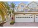 Charming home featuring a two-car garage, well-maintained landscaping, and a beautiful brick driveway at 1768 Lago Vista Blvd, Palm Harbor, FL 34685