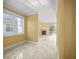 Hallway with tile floors leads to bright living room, offering an open and airy feel at 1768 Lago Vista Blvd, Palm Harbor, FL 34685