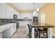 Modern kitchen with sleek countertops, updated appliances, a breakfast bar, and stylish backsplash at 1768 Lago Vista Blvd, Palm Harbor, FL 34685