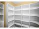 Spacious walk-in pantry with white shelving offering ample storage space at 1768 Lago Vista Blvd, Palm Harbor, FL 34685
