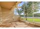 Relaxing screened-in patio offers a lovely waterfront view and ceiling fan for added comfort at 1768 Lago Vista Blvd, Palm Harbor, FL 34685