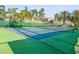 Well-maintained tennis court with green and blue surface, perfect for active community residents at 1768 Lago Vista Blvd, Palm Harbor, FL 34685