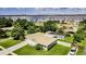 Aerial view of home with attached garage, screened-in pool, and waterfront view in the distance at 1829 1St E Ave, Bradenton, FL 34208