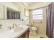 Bathroom featuring a modern vanity, new floors, and tile walls at 1829 1St E Ave, Bradenton, FL 34208