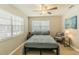 This bedroom features tile flooring, a ceiling fan, and a large window for natural light at 1829 1St E Ave, Bradenton, FL 34208