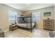 Bedroom with a bunk bed, dresser, and flooring at 1829 1St E Ave, Bradenton, FL 34208