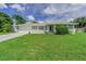 Charming single-story home with a well-maintained lawn, white picket fence, and a two-car garage at 1829 1St E Ave, Bradenton, FL 34208