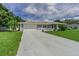 Charming single-story home with a gray exterior, attached garage and well-manicured lawn at 1829 1St E Ave, Bradenton, FL 34208
