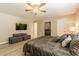 This main bedroom features light wood floors, a ceiling fan, and a sitting area with storage at 1829 1St E Ave, Bradenton, FL 34208