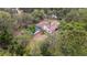 Beautiful aerial view of property featuring a screened pool and nestled among lush trees at 18546 Kelly Rd, Spring Hill, FL 34610