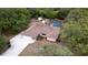 Aerial view of home showcasing the spacious lot, screened-in pool, and mature trees at 18546 Kelly Rd, Spring Hill, FL 34610