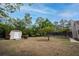 Large backyard featuring mature trees, a shed, and plenty of space for outdoor activities at 18546 Kelly Rd, Spring Hill, FL 34610