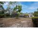 The backyard features a screened enclosure and is surrounded by mature landscaping at 18546 Kelly Rd, Spring Hill, FL 34610