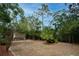 Backyard includes a storage shed bordered by various trees and shrubbery at 18546 Kelly Rd, Spring Hill, FL 34610