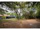 Expansive backyard features mature trees and a screened enclosure, perfect for outdoor enjoyment at 18546 Kelly Rd, Spring Hill, FL 34610