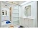 Contemporary bathroom with dual vanities, white cabinets, a shower and sliding glass door at 18546 Kelly Rd, Spring Hill, FL 34610