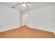 Clean bedroom with light wood floors, closet, and ceiling fan at 18546 Kelly Rd, Spring Hill, FL 34610