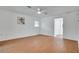 Minimalist bedroom showcasing wood floors, neutral walls and a ceiling fan at 18546 Kelly Rd, Spring Hill, FL 34610