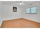 Well-lit bedroom with light wood flooring, a window, and neutral walls at 18546 Kelly Rd, Spring Hill, FL 34610