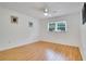 Well-lit bedroom with wood flooring and bright natural light through a window at 18546 Kelly Rd, Spring Hill, FL 34610