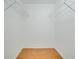 Walk-in closet with wood floor, white walls, and wire shelving at 18546 Kelly Rd, Spring Hill, FL 34610